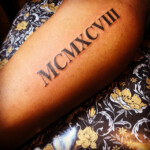 Nyck Roman Numerals Black Tattoo Lettering GOLD STRIPE TATTOO